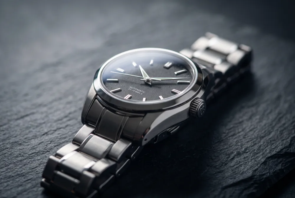 Nano Banana 2.1 macro photo of a steel wristwatch on slate with the full dial in focus